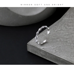 Macro detail of geometric faceted gold ring with mirror polished surface on stone