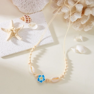 Detail of adjustable woven necklace with plumeria flower and natural shells for beach