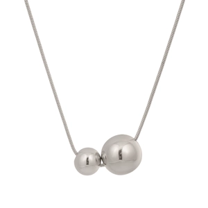 Detail of silver-toned snake chain necklace featuring two geometric metal sphere pendants