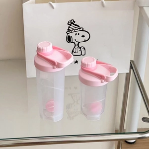 Detail view of pink frosted shaker bottles with large carry handle and mixing ball