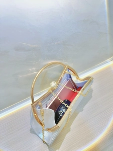 Elegant silver evening clutch bag with gold handle showing interior phone storage