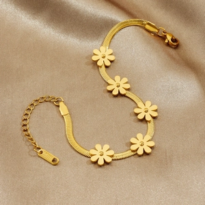 Gold daisy flower bracelet in stainless steel on a luxury champagne silk background
