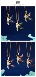 Detailed macro view of hummingbird pendant with gradient wings and heart-shaped zircon