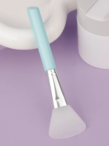 Detail of soft silicone spatula brush with silver metal tube for facial mud masks
