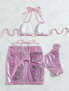 Detailed flat lay of pink snakeskin print bikini set with metal ring and matching skirt