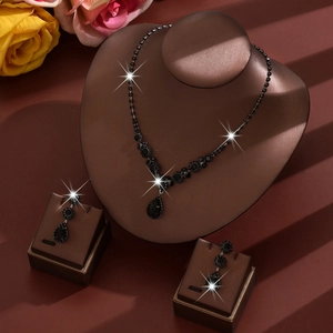 Luxurious water-drop rhinestone jewelry set with black gems on an elegant display