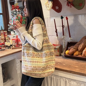 Winter fluffy striped tote bag carried by model in a cozy festive Christmas setting