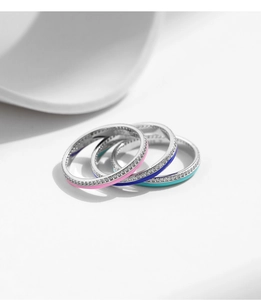 Detail of three S925 sterling silver rings with colorful enamel and pavé setting stones