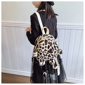 Detail view of plush leopard print toddler backpack with cute round ears and white straps