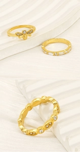 Detailed view of 18K gold plated rings featuring bee, geometric, and wave patterns with zircons
