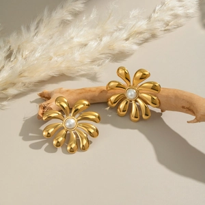 Detail of 18K gold-plated flower stud earrings featuring a white pearl center on a branch