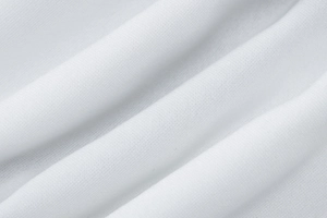 Close-up of white knitted fabric texture showing premium weave and soft flexibility