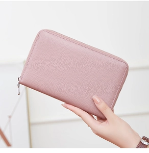 Close-up of pink litchi grain cowhide leather wallet with silver zipper detail