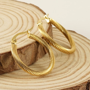 18K gold plated stainless steel twisted rope hoop earrings on natural wood background