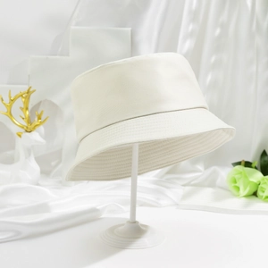 Minimalist cream white reversible cotton bucket hat with clean stitching and elegant aesthetic