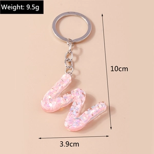 Pink glitter resin letter M keychain with silver ring and detailed size measurements