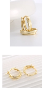 Detailed macro view of S925 sterling silver stamp on minimalist gold double hoop earrings