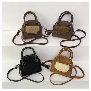 Detail view of plush crossbody bags in dark brown, coffee, black, and camel colors
