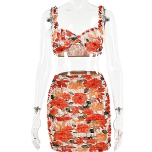 Detail of red floral lace crop top and matching ruched mini skirt set on a mannequin