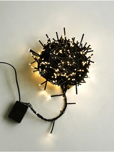Macro shot of warm white LED light string with black cable for holiday site decoration