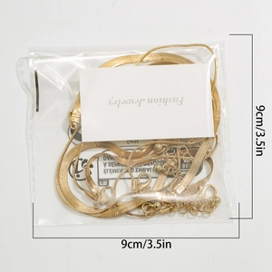 Detail view of layered gold snake chain necklace set with 9cm jewelry packaging card