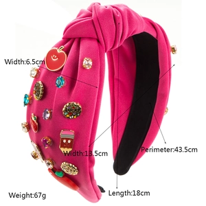 Magenta headband with apple and pencil motifs featuring a knotted fabric design