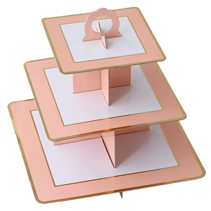 Detail of 3-tier square pink paper cupcake stand with golden edges for party decor