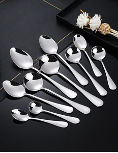 Polished stainless steel spoon set in various sizes on a black reflective surface
