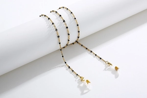 Close-up of golden O-chain with black beads and silicone anti-slip loops for eyewear