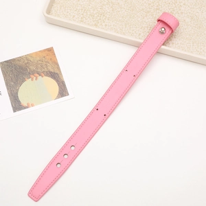 Macro detail of a pink leather phone wrist strap with silver snap button and adjust holes