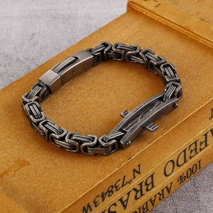 Retro silver steel cross bracelet for men with vintage link chain design on wood