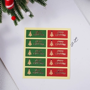 Detail of red and green Christmas stickers with gold foil Merry Christmas and tree designs
