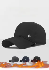Close-up of insulated wool baseball cap with metal R-logo and warm ear protection flaps