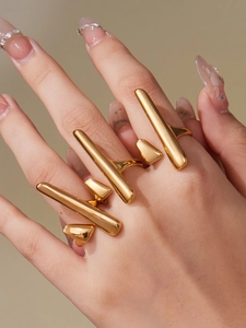 Detail shot of irregular geometric gold rings set with minimalist industrial design