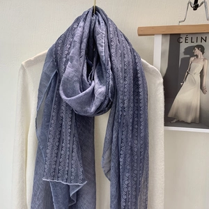 Detailed view of the delicate lace trim on a light blue linen cotton shawl for women