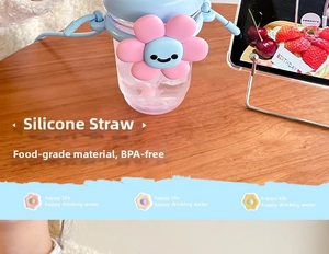 Close-up of BPA-free plastic water bottle with pink sunflower and silicone straw detail