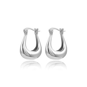 Detailed macro view of silver-toned U-shaped hoop earrings with polished metal finish