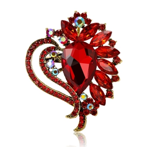 Vintage style red crystal brooch with teardrop gemstone and bronze metallic base