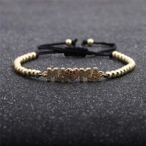 Detail of adjustable MAMA bracelet with gold beads and purple zircon heart element