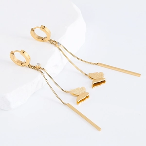 Elegant gold butterfly tassel earrings with crystals on a white stone base