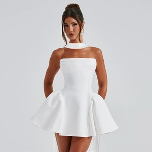Detail of white tube mini dress featuring structured waist and layered ruffled hemline