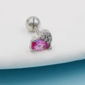 Macro detail of heart stud earring with pink pear-cut zircon and silver steel ball back