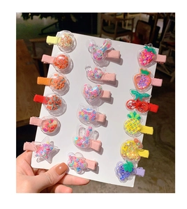 Macro detail of children hair clips with colorful sequins and fruit shapes on white card
