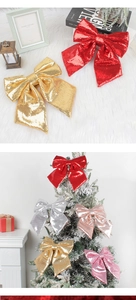 Macro detail of large sequined Christmas bows in red and gold on a festive tree
