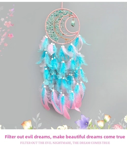 Detail of moon-shaped dream catcher with turquoise tree of life and pink feathers