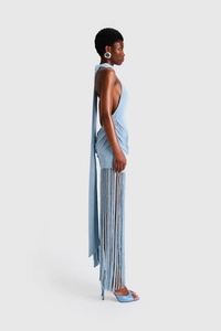 Side view of light blue halter knit dress featuring long fringes and open back detail