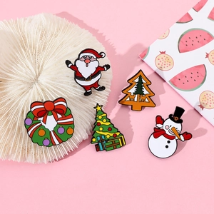 Detailed close-up of 5-piece Christmas enamel pin set featuring Santa, Snowman and Trees