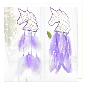 Detailed close-up of handmade purple unicorn dreamcatchers with feathers and beads