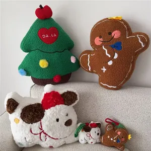 Detailed view of plush Christmas tree and gingerbread man pillows on a soft sofa