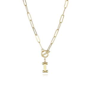 Detail of gold paperclip chain necklace with a toggle clasp and letter I pendant